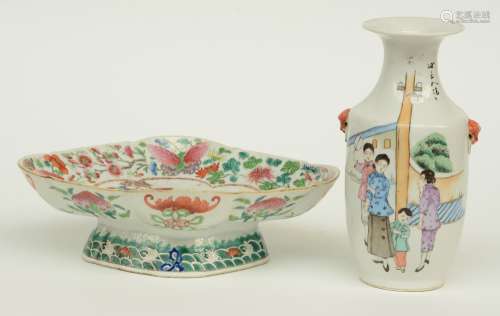 A Chinese famille rose plate, the roundel decorated with an animated scene, marked, 19thC; added a Chinese polychrome vase decorated with figures, H 9 - W 28,5  - D 22 cm; H 23 cm (chips on the rim)