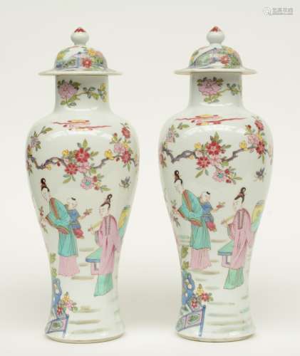 Two Chinese famille rose baluster shaped vases and covers, decorated with figures in a garden, H 36,5 cm