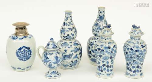 Two Chinese blue and white calabash vases and two vases and covers, decorated with dragons, birds and floral motifs, marked 18th - 19thC; added a ditto ewer with cover and vase with silver mount and cover, H 13 - 20 cm