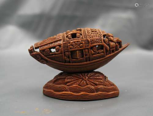 A CHINESE WALNUT AND OLIVE CARVING