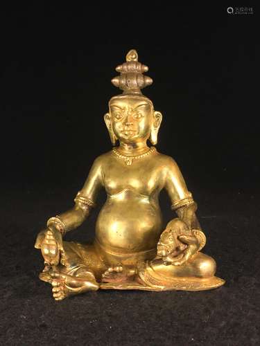 CHINESE GILT BRONZE FIGURE OF JAMBHALA