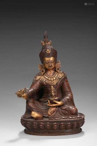 A parcel-gilt bronze guru figure