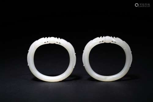 A pair of white jade dragon bracelets