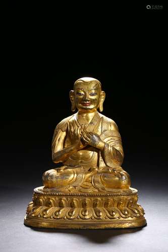 A gilt-bronze figure of guru