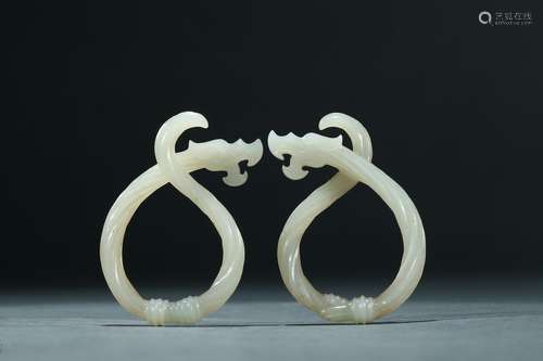 A pair of white jade rope-twisted dragon pendants