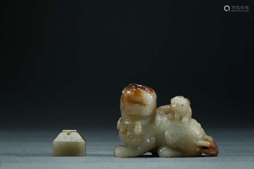 A carved white jade beast and a small jade seal