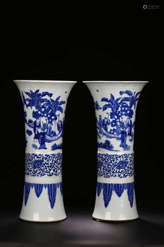 A pair of white and blue 'figure' beaker vase