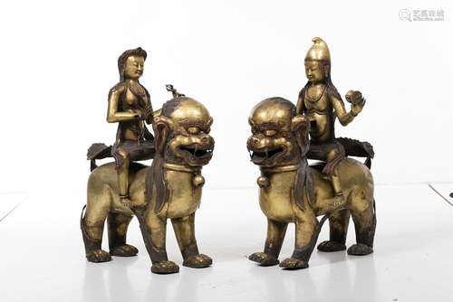 Tibetan gilt copper Lama and Bodhisattva figures riding qilin