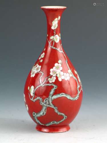 Chinese red glazed vase with famille rose flower decorations.