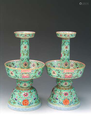 A pair of famille rose green glazed candle holders.