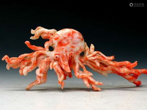 Carved red coral in the shape of a octopus.