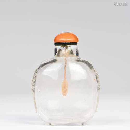 A GLASS SNUFF BOTTLE WITH CORAL LID