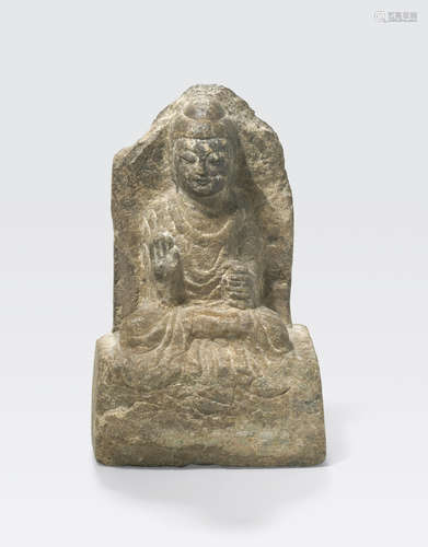 A carved stone figure of a Buddha Late Six Dynasties