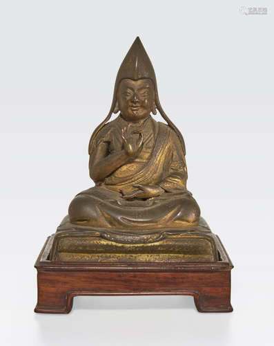 A small gilt bronze Gelugpa lama Tibeto/Chinese, 19th century