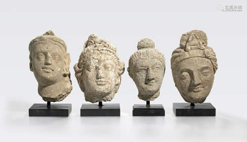 A group of four stucco heads of youths, noblemen, and the Buddha Ancient region of Gandhara, 4th/5th century