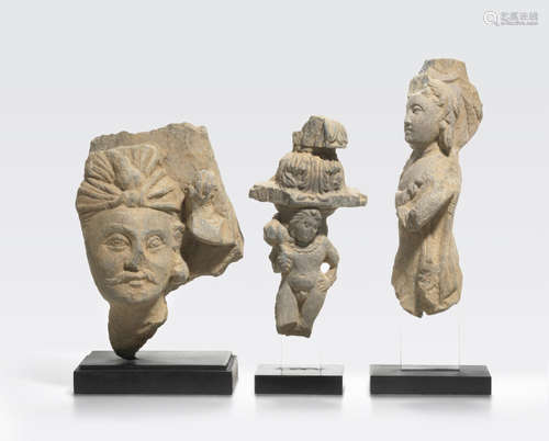 A schist head of a bodhisattva and two schist figures Ancient region of Gandhara, 3rd/4th century