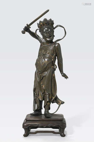 A cast bronze figure of a guardian deity 16th/17th century