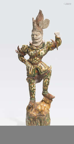 An impressive sancai glazed pottery guardian figure Tang dynasty