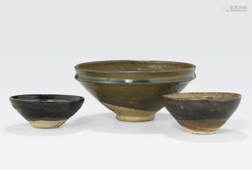 A group of three brown glazed ceramic bowls 12th/13th century