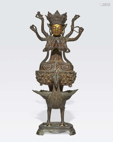 A cast bronze Buddhist figure on a peacock