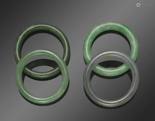 A group of four jade bangles