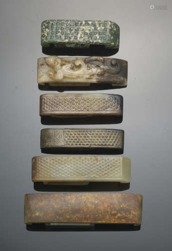 A group of six archaistic jade and hardstone scabbard slides
