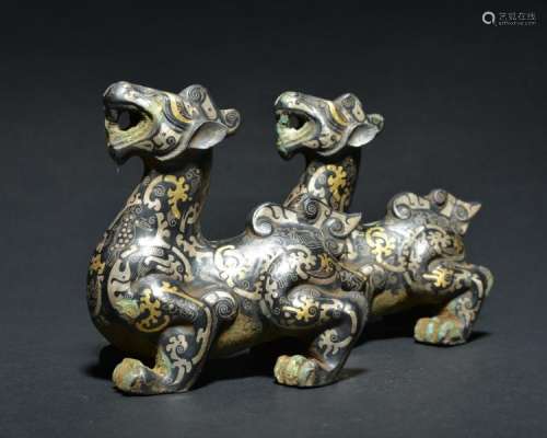 A PAIR OF GOLD-SILVER INLAID BRONZE BEASTS , Han Dynasty