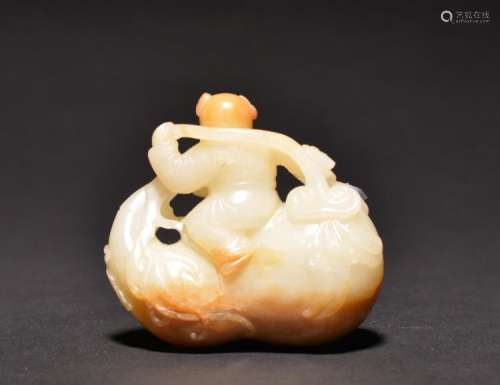 A CARVED WHITE -RUSSET JADE BOY , Qing Dynasty