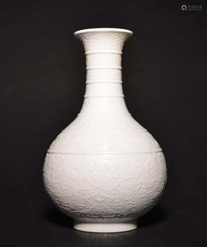 A CARVED WHITE-GLAZED BOTTLE VASE , Qing Dynasty