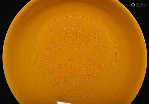 A CARVED YELLOW-GLAZED DRAGON DISH , Ming Dynasty