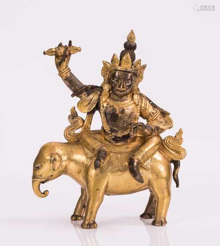 TIBETAN GILT BRONZE DEITY ON ELEPHANT