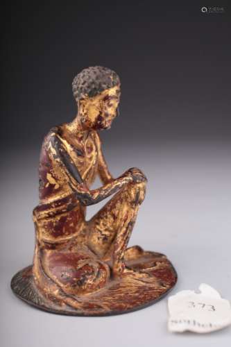 A gilt bronze figure of an emaciated Luohan,
