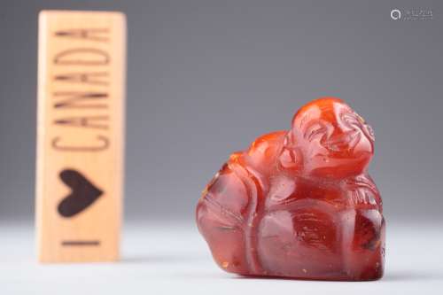 A red amber figure of Budai, Qing dynasty,
