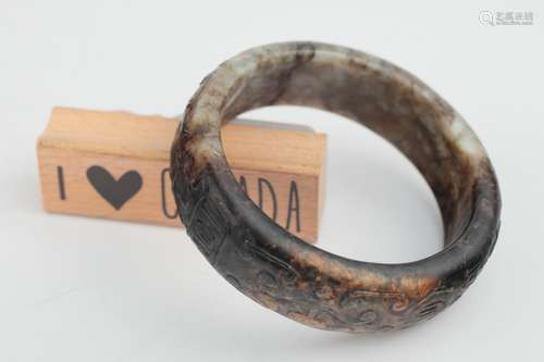 A mottled jade archaistic bangle, Ming dynasty,