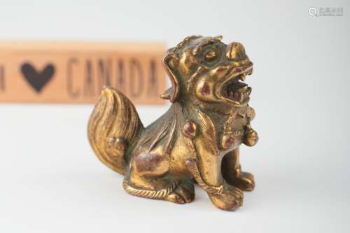 An inscribed Chinese gilt bronze Foo dog, 18th c.,