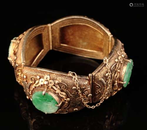 A heavy silver gilt mounted jadeite bracelet,