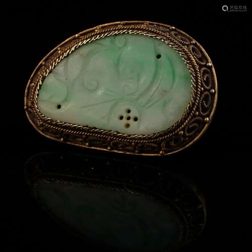 A carved jadeite brooch, filigree silver mounted,