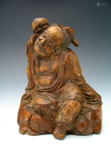 Chinese bamboo carving of an old man and a boy.