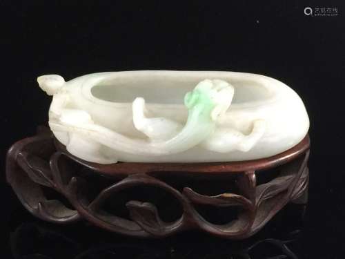 Chinese jadeite water coupe on wood stand.