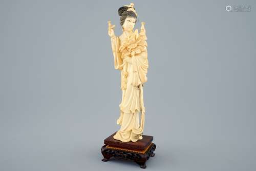 A Chinese carved ivory figure of a lady on wooden base, early 20th C.