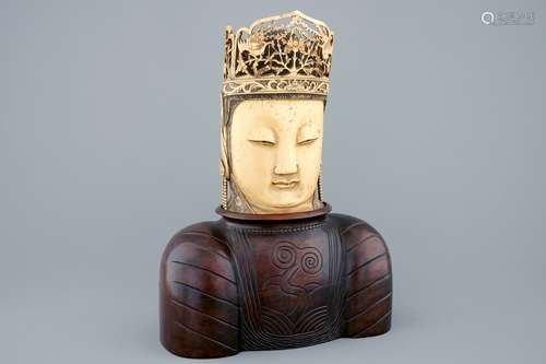 A Chinese carved ivory head of Buddha on wooden stand, 19th C.