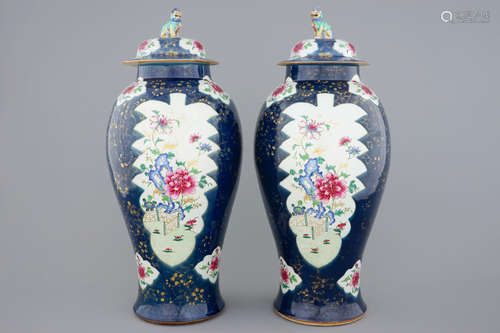 A tall pair of Chinese famille rose powder blue ground vases with covers, Qianlong, 18th C.