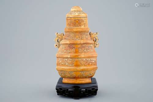 A Chinese parcel-gilt ivory vase and cover on wooden stand, 19th C.