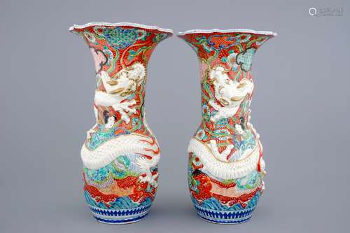 A tall pair of Japanese relief-moulded dragon vases, 19th C.