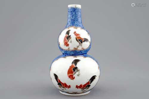 A Chinese blue ground double gourd vase with roosters, 18/19th C.