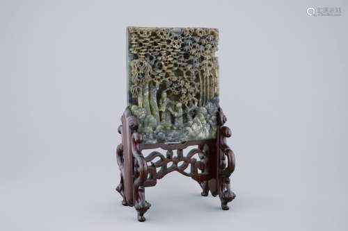 A deeply carved Chinese spinach jade table screen, 19/20th C.