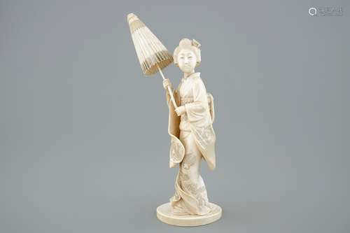 A Japanese carved ivory okimono of a lady holding a parasol, 19th C.