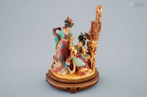A Chinese polychrome carved ivory group on wooden base, 19th C.
