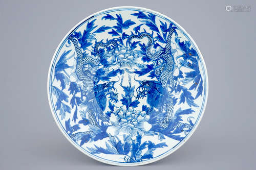 A blue and white Chinese dish with dragons among peony, 19th C.