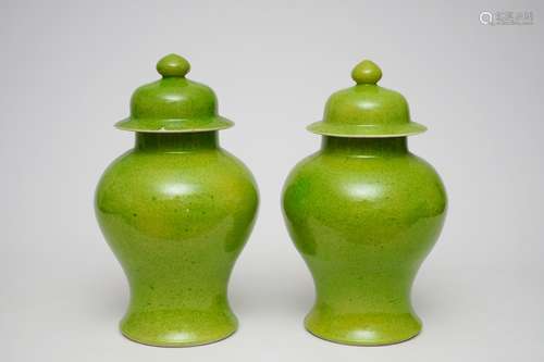 A pair of Chinese monochrome lime green vases and covers, 19/20th C.